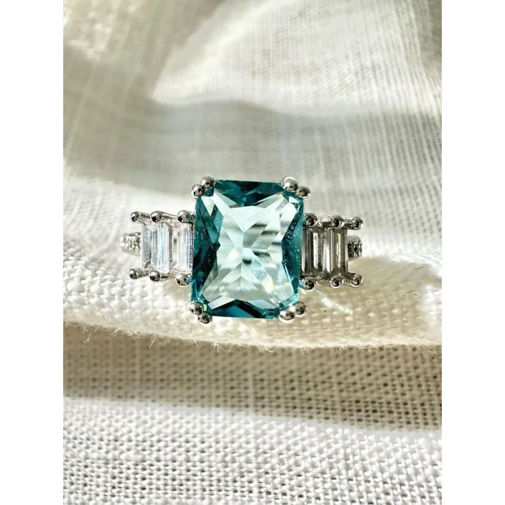 Light blue elongated radiant cut ring
